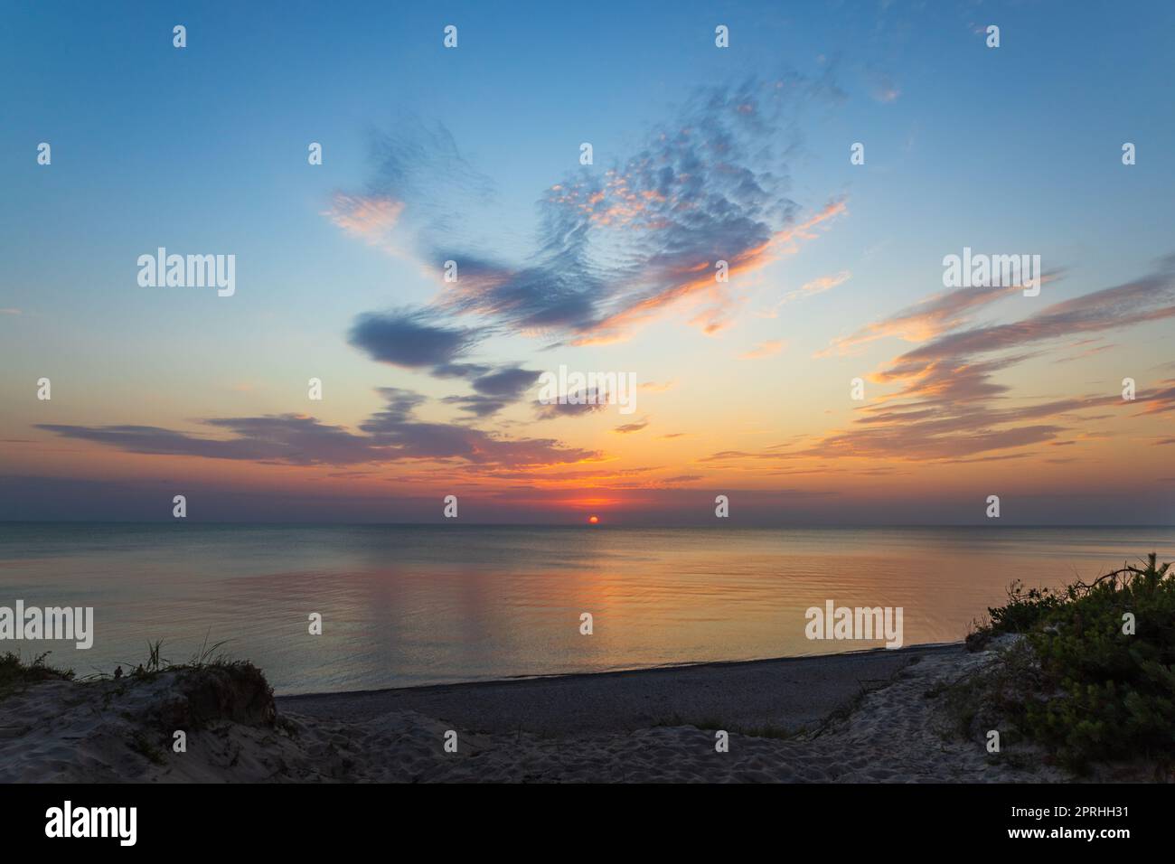 Tramonto e mare blu con onde al Mar Baltico Foto Stock