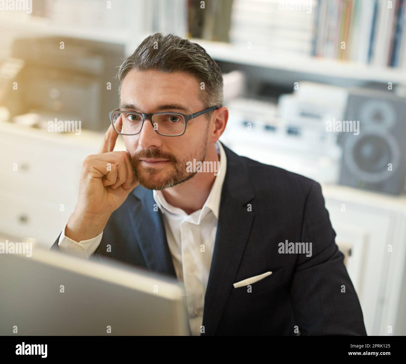Im che si prende cura del business. Ritratto di un uomo d'affari che lavora al suo computer in un ufficio. Foto Stock