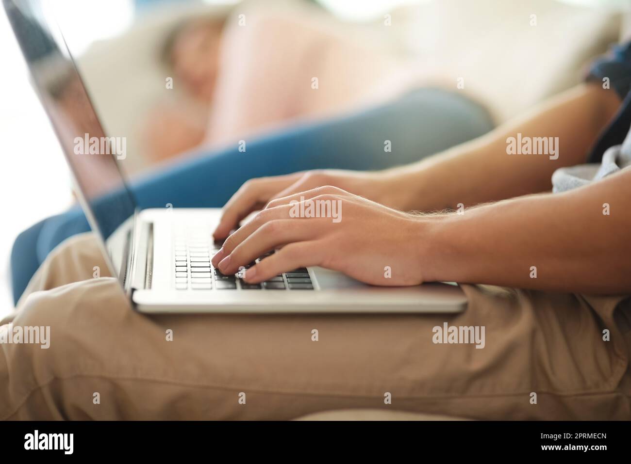 Uomo bello nel grembiule in piedi in cucina e di lavoro sul computer  portatile Foto stock - Alamy