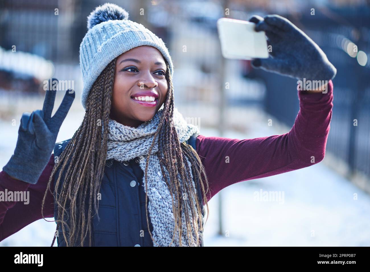 Non è il giorno della neve fino a quando non si prende un selfie. una bella giovane donna che prende un selfie in una giornata innevata all'aperto Foto Stock