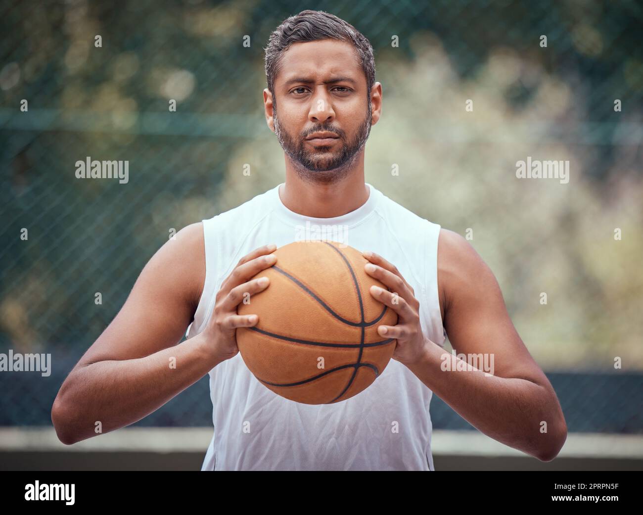 Campo da pallacanestro, uomo e ritratto serio con palla in un luogo sportivo all'aperto per esercitarsi. Atleta competitivo, forte e maturo che pensa a una strategia di gioco per una partita esterna. Foto Stock