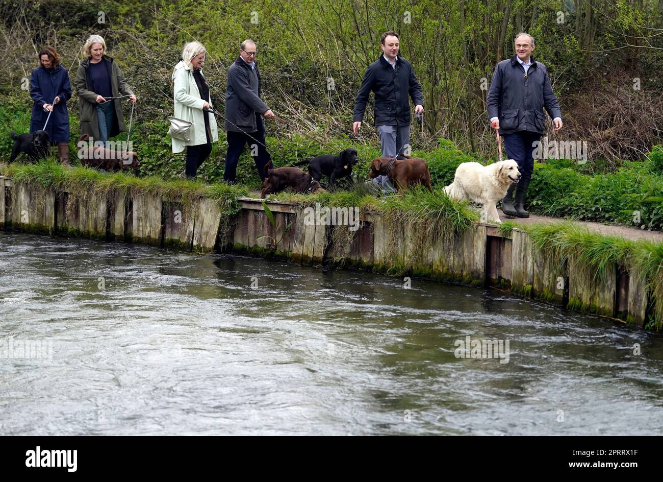 Il leader democratico liberale Sir ed Davey (a destra) e Danny Chambers, il candidato parlamentare dei liberali democratici per la Ford di Winchester & Chandler (2nd a destra), durante una passeggiata con i cani lungo il fiume Itchen vicino a Winchester, un flusso di gesso che è stato danneggiato dagli scarichi delle acque reflue. Data immagine: Giovedì 27 aprile 2023. Foto Stock