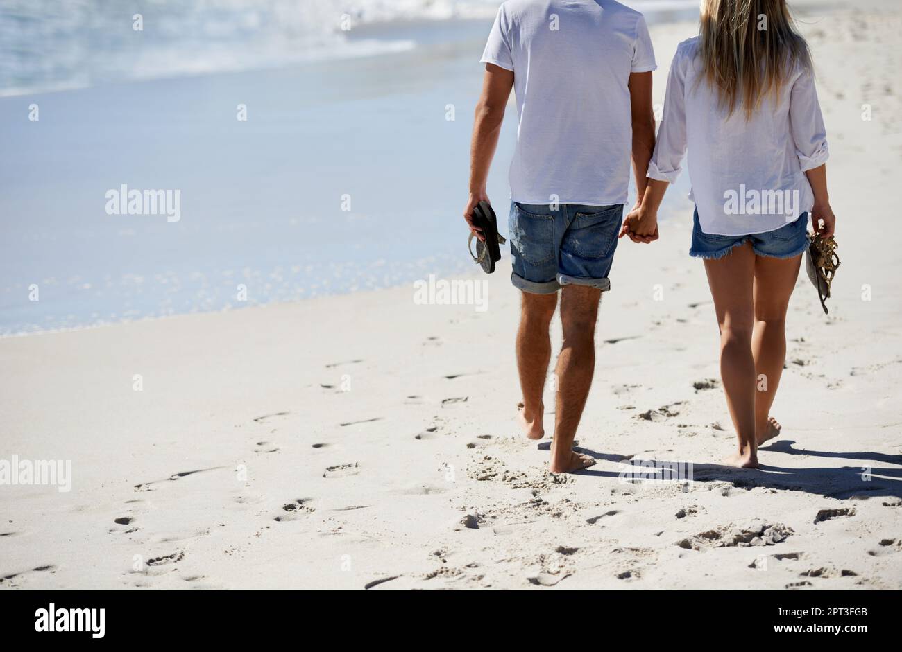 Partner di stimolazione. Immagine ritagliata di una coppia che cammina sulla spiaggia Foto Stock
