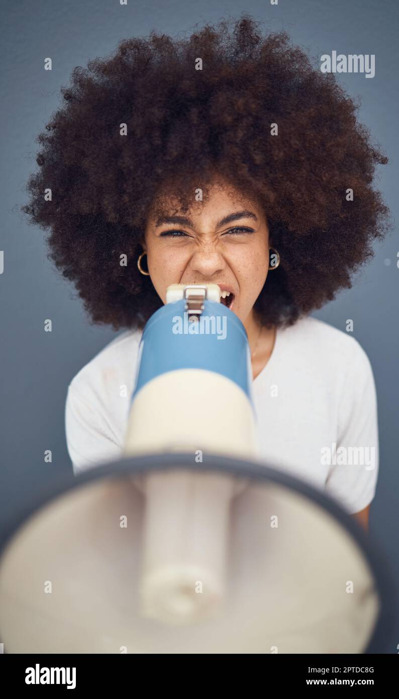 Donna, megafone e grida di protesta, opinione e voce per la giustizia sociale in uno studio di background. Speaker, donna latino e ragazza ritratto spea Foto Stock