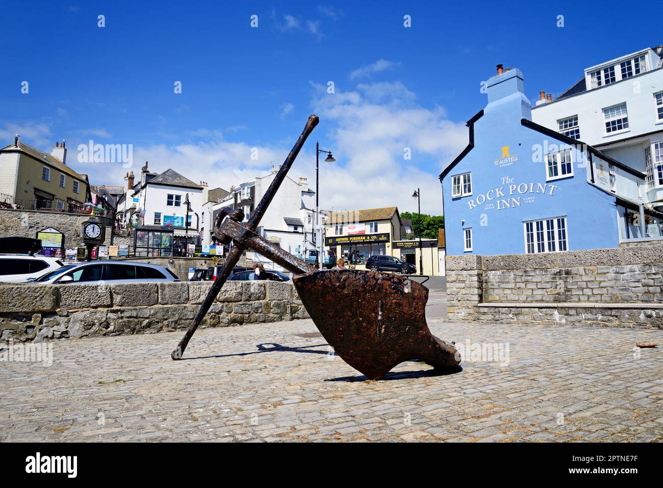 Grande ancora visualizzata lungo il lungomare con il Rock Point Inn e negozi sul retro, Lyme Regis, Dorset, Regno Unito, Europa. Foto Stock