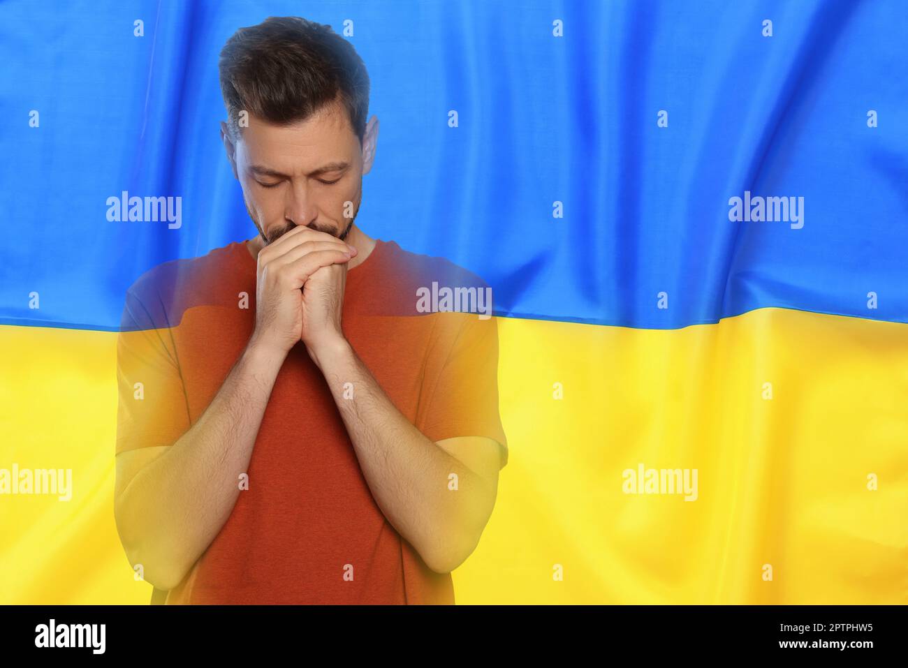 Doppia esposizione della bandiera nazionale e l'uomo che prega. Fermare la guerra in Ucraina Foto Stock