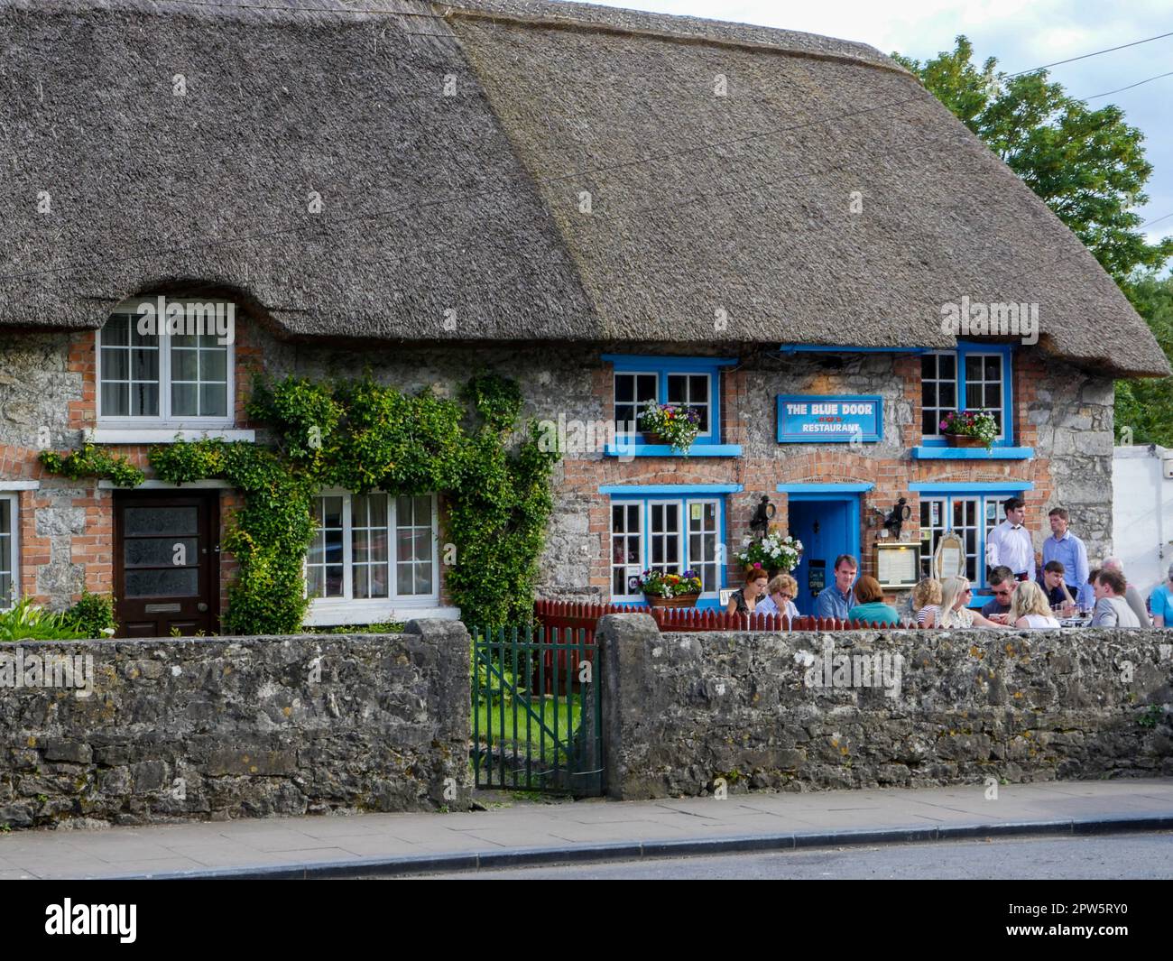 Le case sul tetto di paglia sono abbondanti nell'affascinante Adare, Irlanda Foto Stock