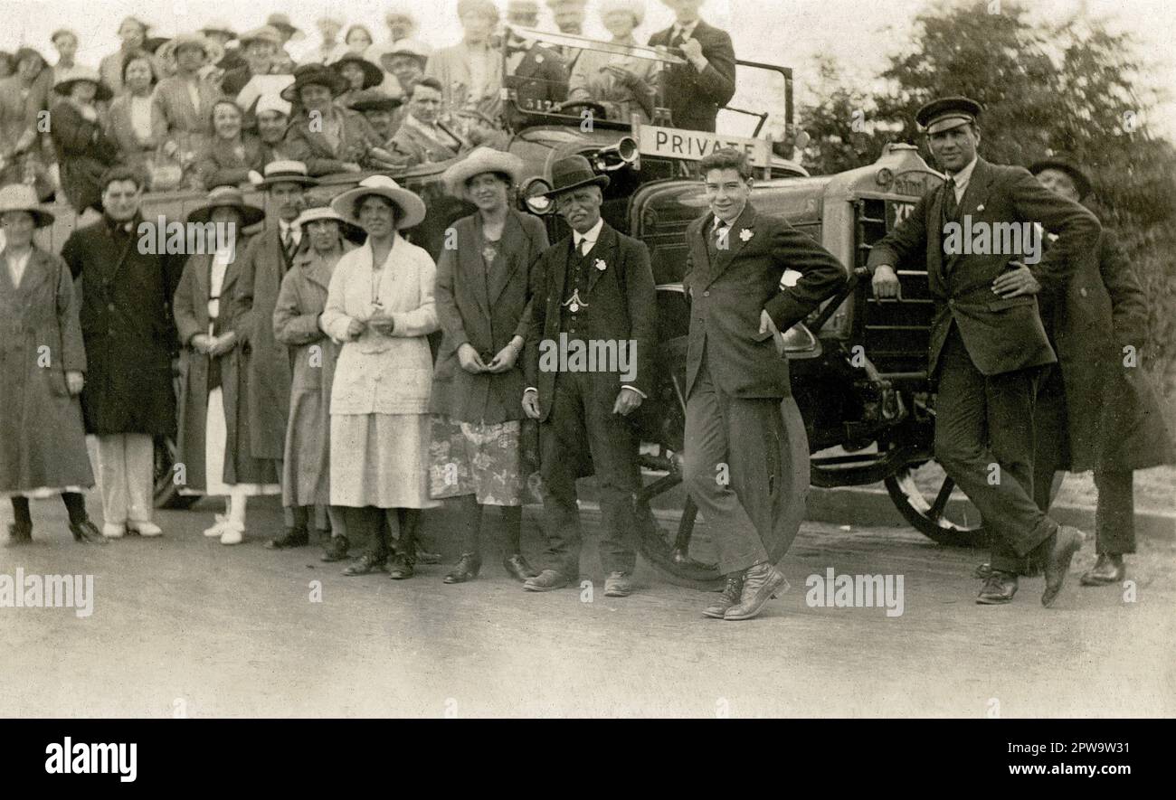 Inghilterra. 1920s. Un gruppo di escursionisti in posa per una fotografia con un noleggio privato Daimler charabanc pullman. Foto Stock