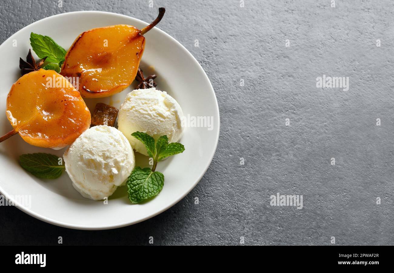 Vista ravvicinata delle palle di gelato con pere in camicia su sfondo di pietra scura con spazio per le copie. Foto Stock