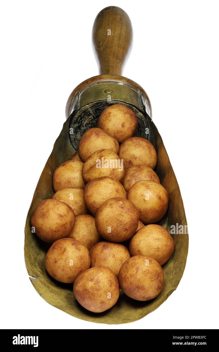 Patate marzapane di Lubecca, Germania, in un misurino di ottone d'annata isolato su fondo bianco Foto Stock