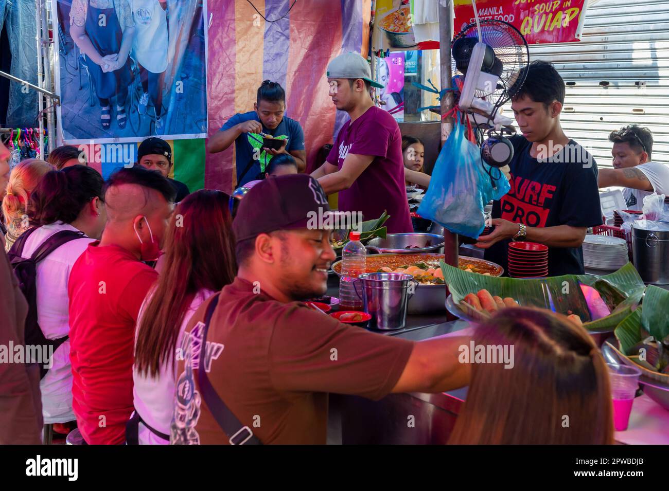 Mangiare cibo di strada filippino al mercato di Quiapo, Manila, Filippine Foto Stock