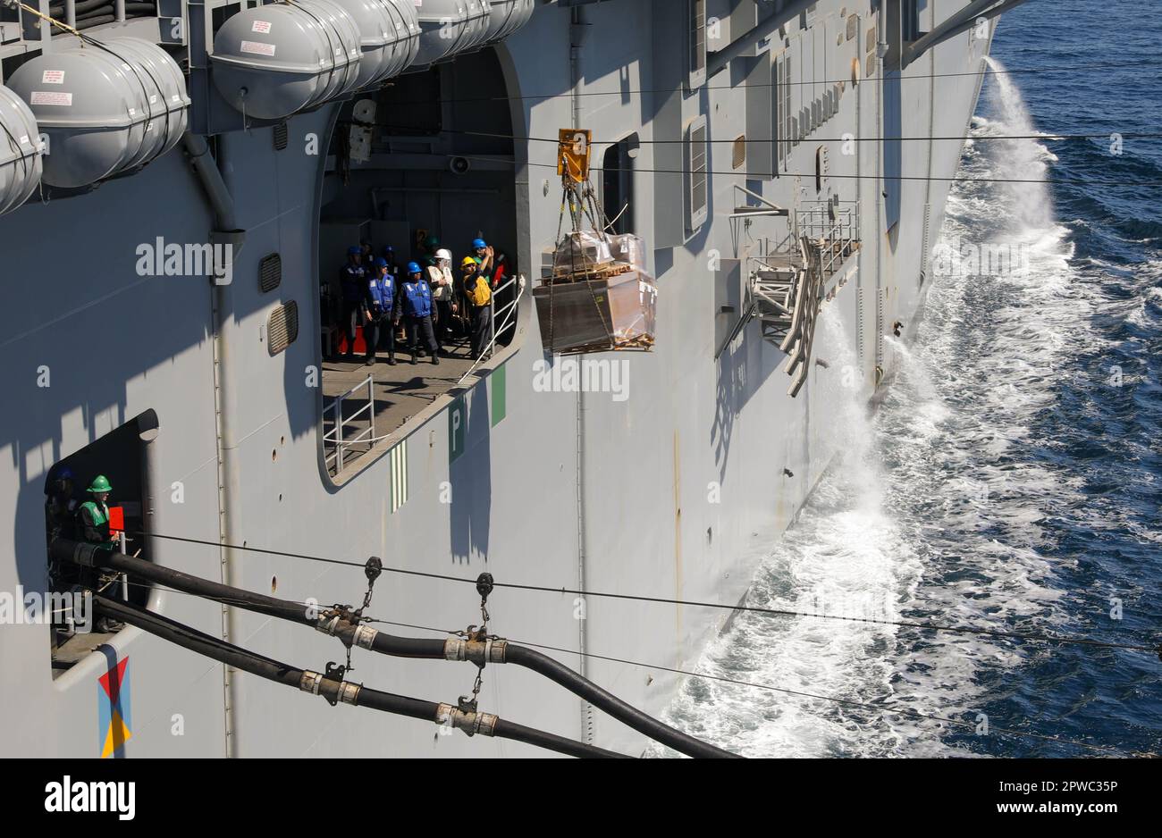 230426-N-XO158-1144 OCEANO ATLANTICO (26 aprile 2023) i marinai ricevono un pallet a bordo della nave d'assalto anfibia USS Wasp (LHD 1) durante un rifornimento collegato (CONREP) con l'oliatore militare di rifornimento del comando di Sealift USNS Leroy Grumman (T-AO 195), 26 aprile 2023. WASP sta conducendo ispezioni e valutazioni della fase base. (STATI UNITI Foto Navy di Mass Communication Specialist 2nd Class Sydney Milligan) Foto Stock