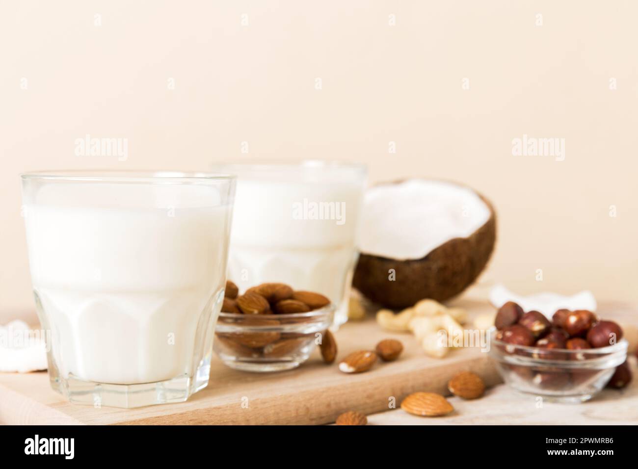 Set o raccolta di vari latte vegano mandorla, cocco, anacardi, su sfondo tavolo. Latte vegetale vegano e ingredienti, vista dall'alto. Foto Stock