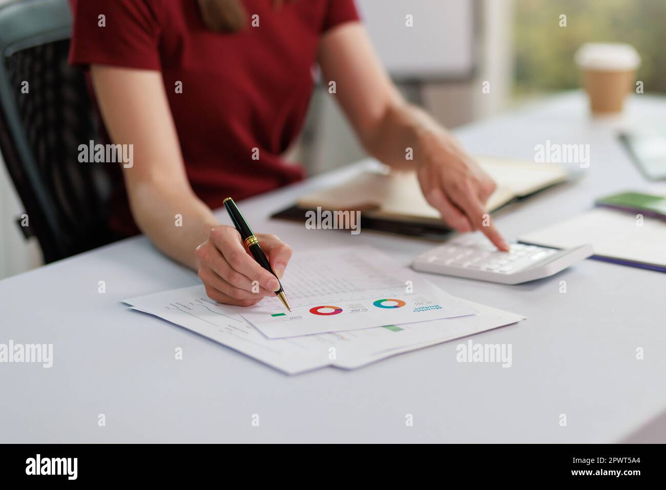 Concetto di business ufficio donna che lavora, Closeup businesswoman che controlla il suo piano di investimento con l'analisi di documenti e dati grafici di investimento aziendale Foto Stock