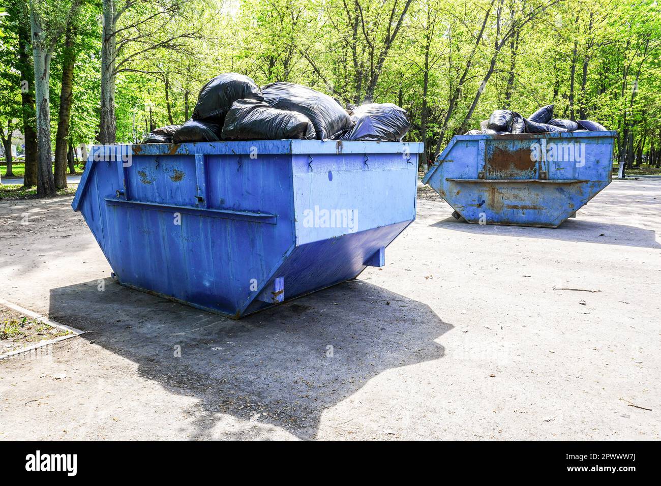 Grandi contenitori di rifiuti in metallo per rifiuti nel parco cittadino Foto Stock