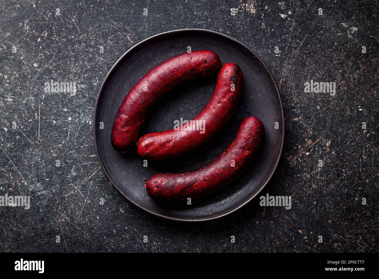 Salsiccia di maiale affumicata sul tavolo nero. Vista dall'alto. Foto Stock