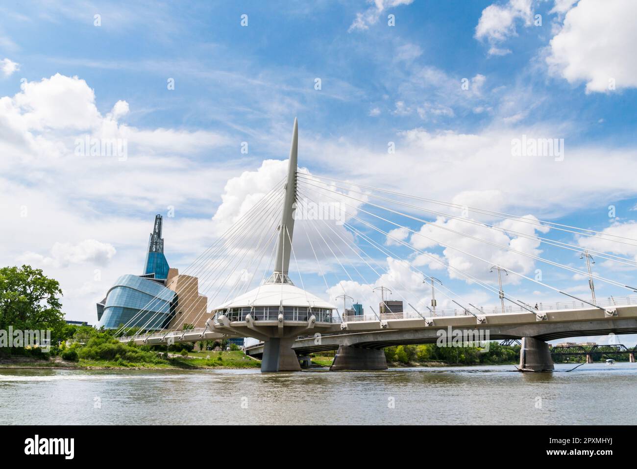 Il ponte pedonale Esplanade Riel attraversa il fiume Rosso nel centro di Winnipeg, Manitoba, accanto al simbolo del museo canadese per i diritti umani. Foto Stock
