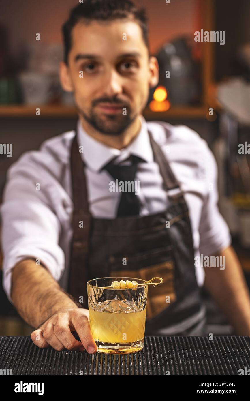 Il barman esperto serve cocktail Foto Stock