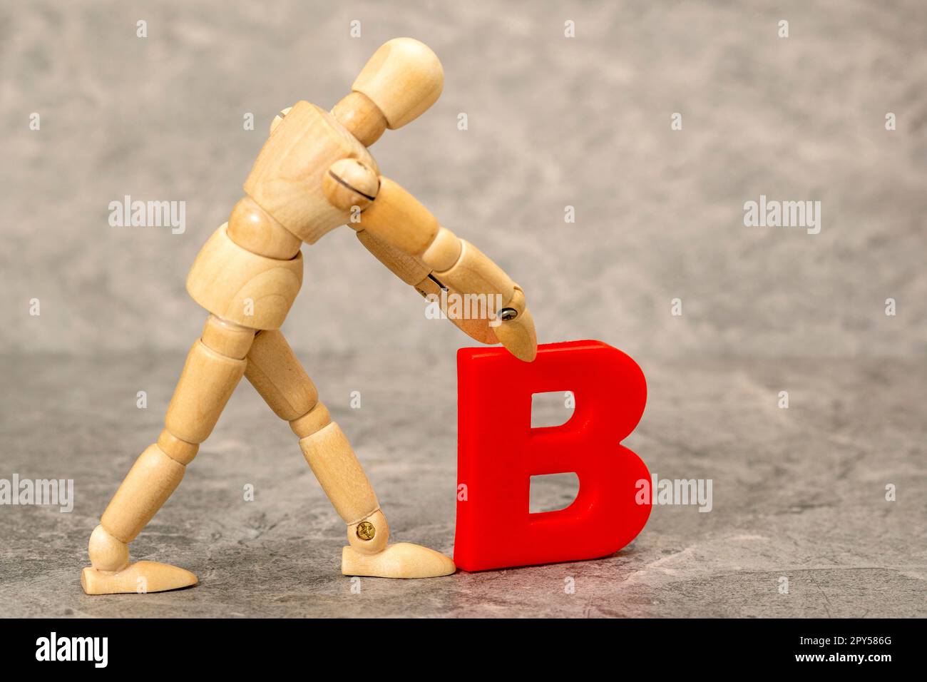 Un manichino di legno contenente una lettera di plastica B. Foto Stock