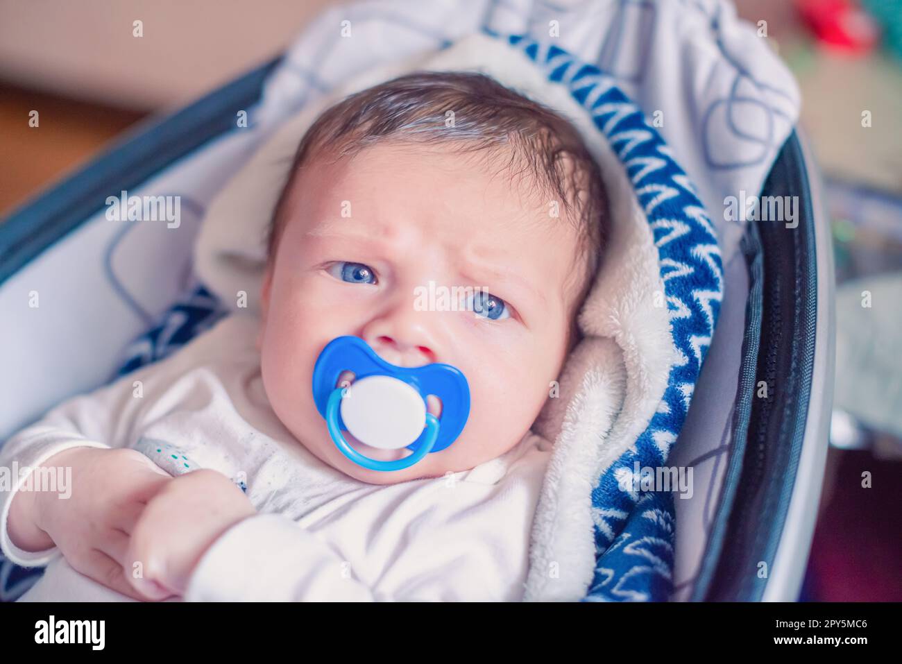 Ritratto di un neonato bianco con un succhietto in bocca Foto Stock