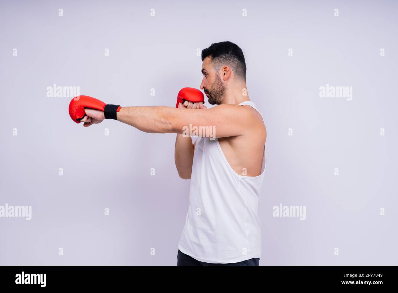 Giovane uomo caucasico bello isolato su sfondo bianco con guanti da boxe Foto Stock