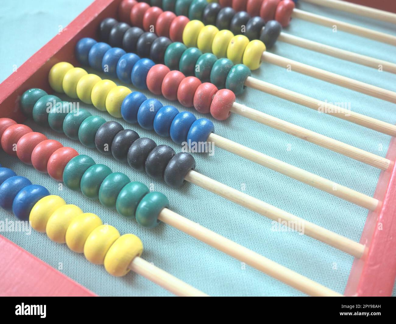 Concetto educativo - abaco con molte perle colorate. Dettagli rossi, blu, verdi, neri e gialli sull'abaco. Esercizi matematici. Programma scolastico Foto Stock