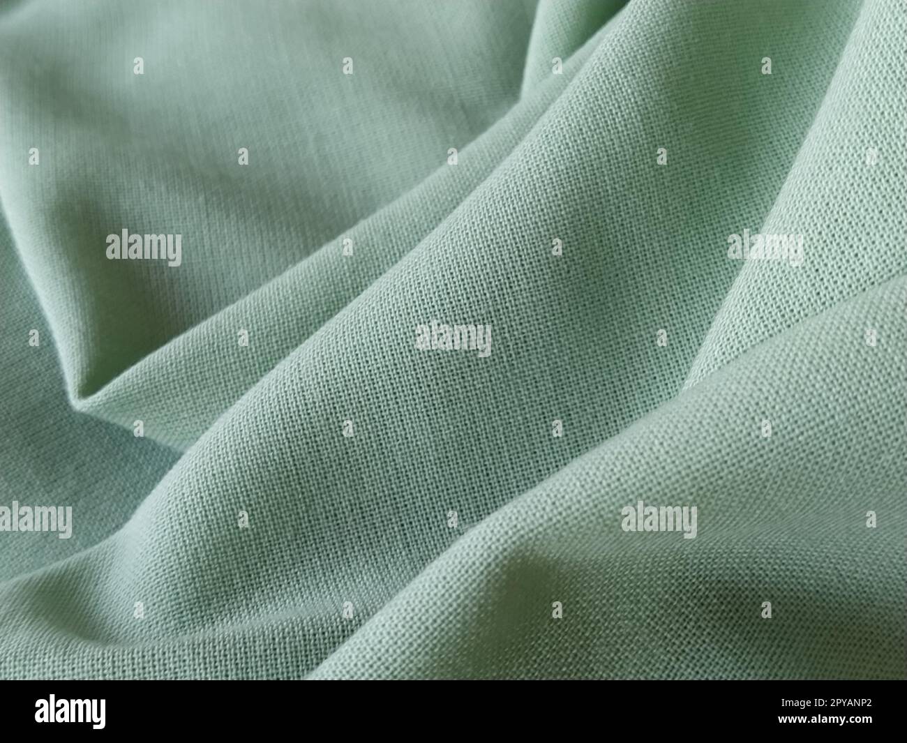 Primo piano di un tessuto di lana di colore verde. Sfondo quadro astratto, modello vuoto. Tessuto naturale sottile, lana o lino Foto Stock