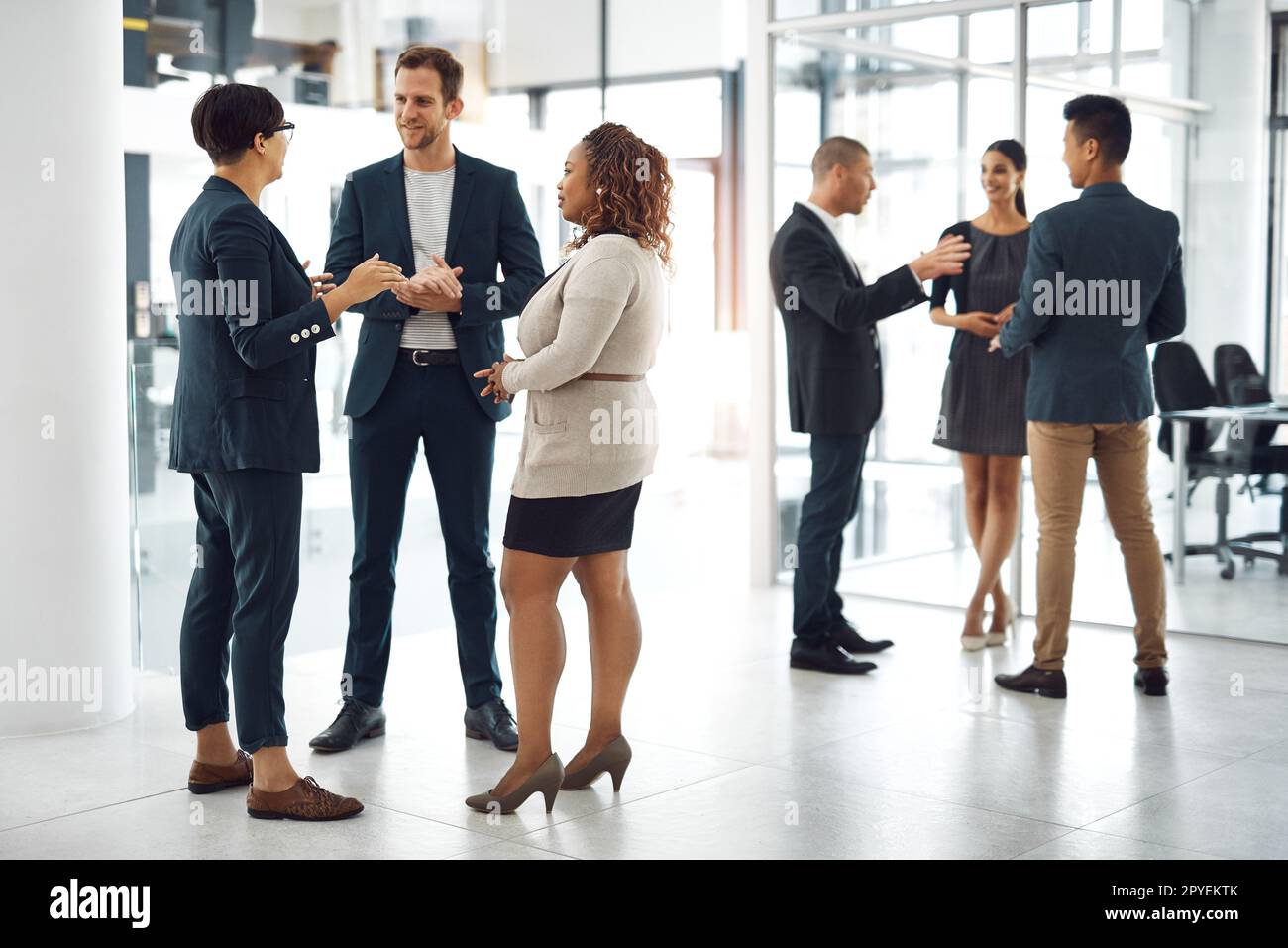 Conversazioni con i colleghi in azienda. gli uomini d'affari che hanno una conversazione in ufficio. Foto Stock