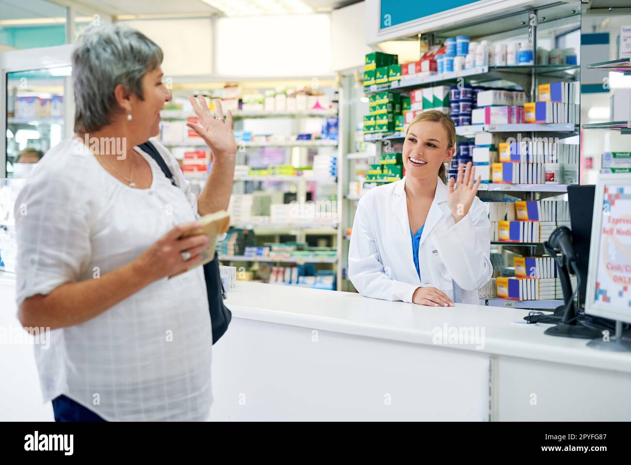 Grazie per il servizio meraviglioso come sempre. una donna matura felice che lascia una farmacia dopo l'acquisto del farmaco. Foto Stock