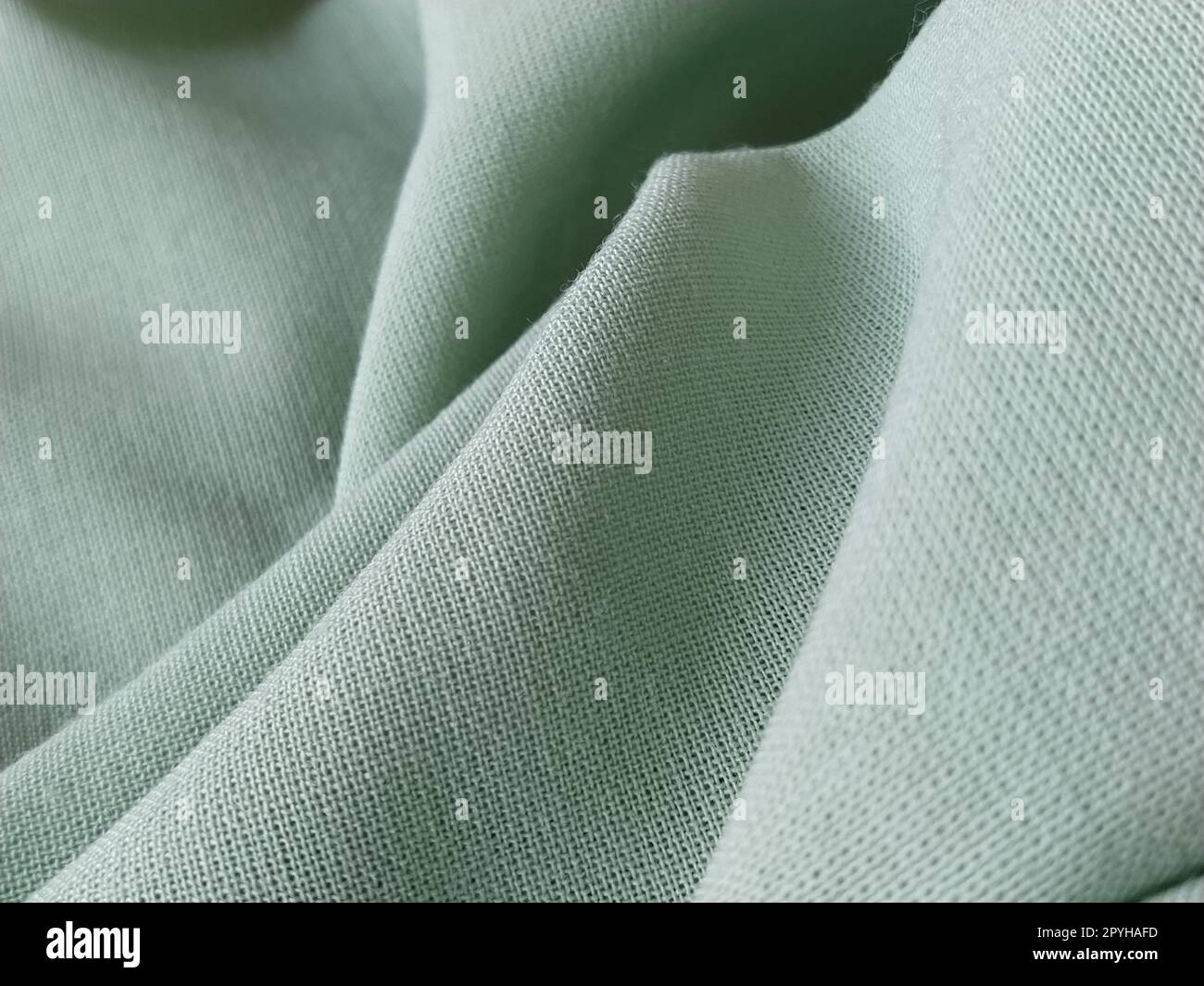 Primo piano di un tessuto di lana di colore verde. Sfondo quadro astratto, modello vuoto. Tessuto naturale sottile, lana o lino Foto Stock