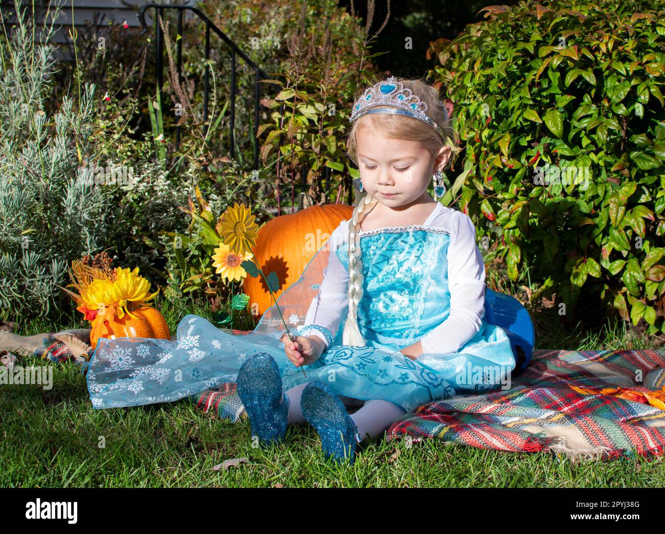 Carina ragazza caucasica vestita come una principessa con tiara. il bambino finge di giocare. Costume di Halloween bambini Foto Stock