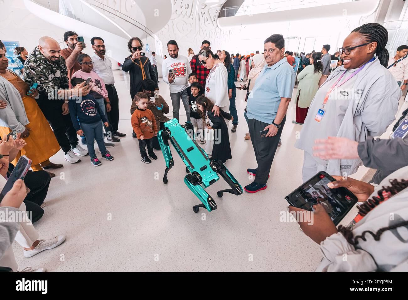 17 gennaio 2023, Dubai, Emirati Arabi Uniti: I bambini sono affascinati dai movimenti del cane robotico e dal modo in cui risponde all'interazione umana, ed essi con impazienza Foto Stock
