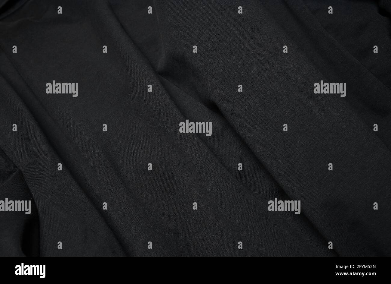 Elegante tessuto di cotone sfondo. Materiale in tessuto nero. Piegare la superficie stropicciata dell'abbigliamento Foto Stock
