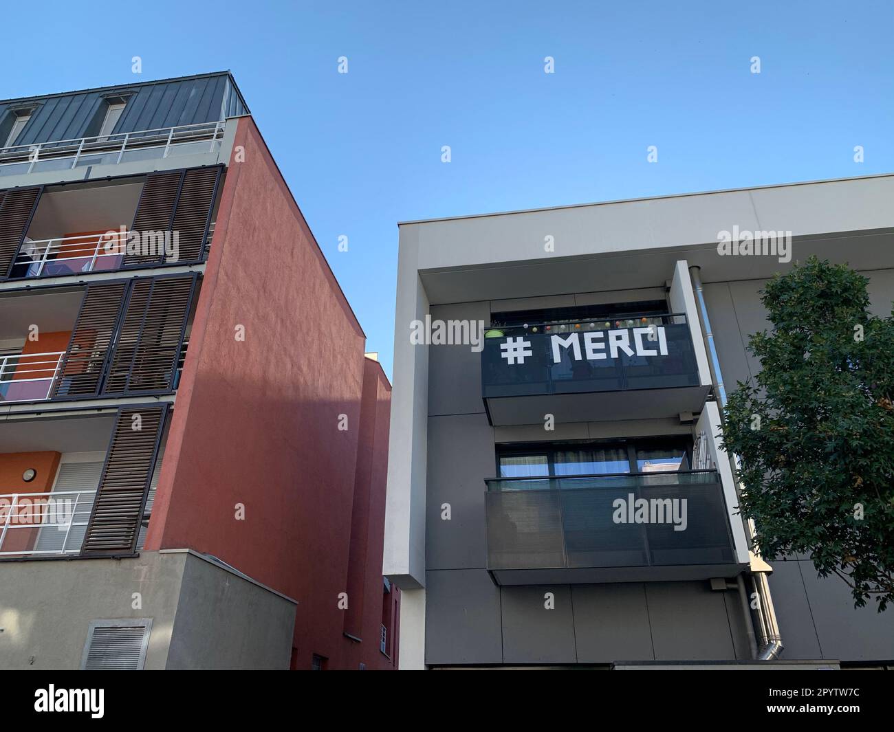 Merci o grazie, gratitudine agli operatori medici durante l'epidemia di covid-19, parola scritta sul balcone di edificio residenziale in Francia Foto Stock