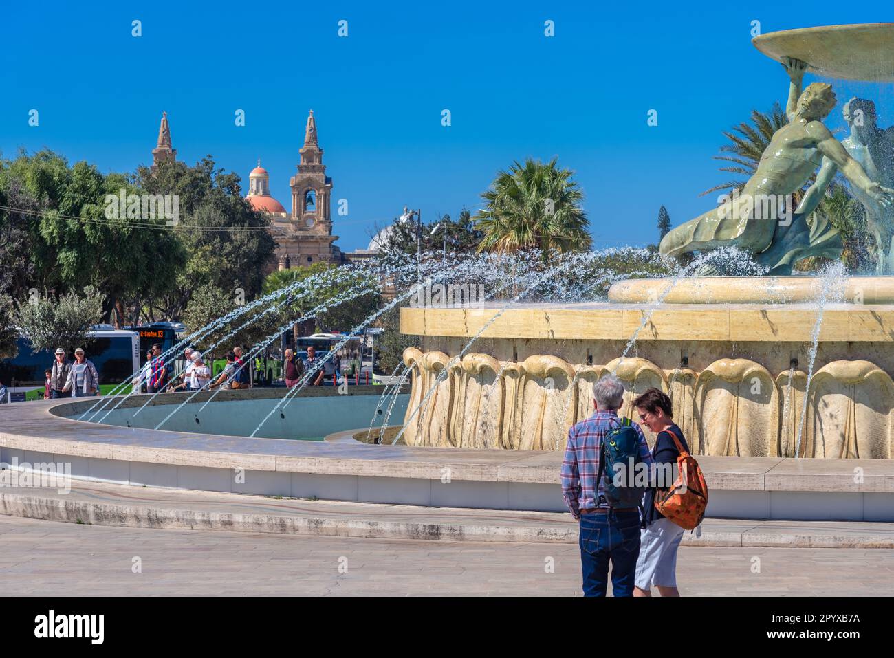 Iconica fontana Tritone di fronte alla porta della città di la Valletta, capitale di Malta Foto Stock