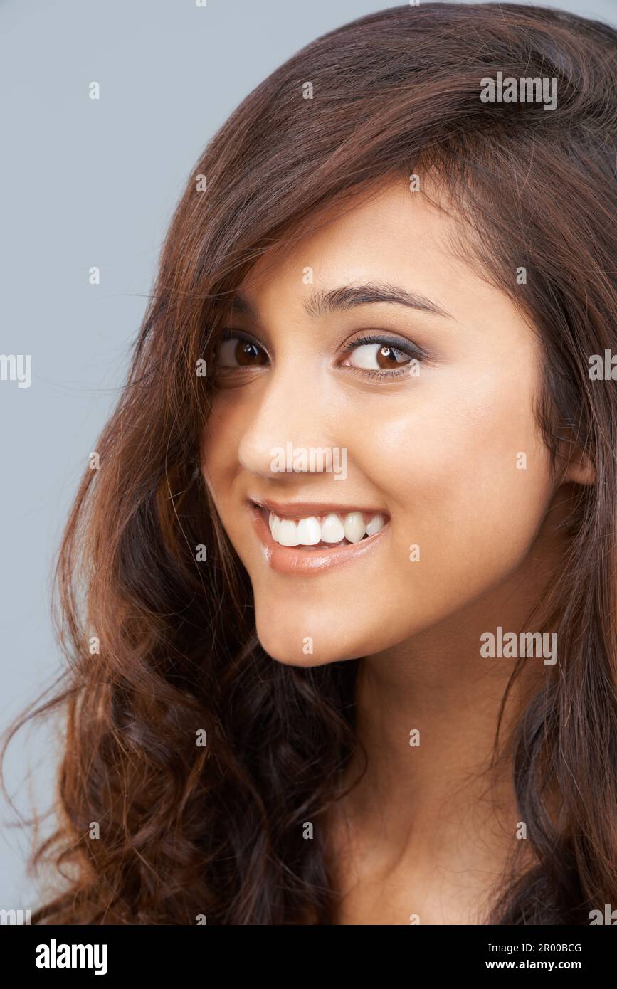 È orgogliosa dei ricci. Ritratto di una bella giovane donna etnica con capelli castani ricci. Foto Stock