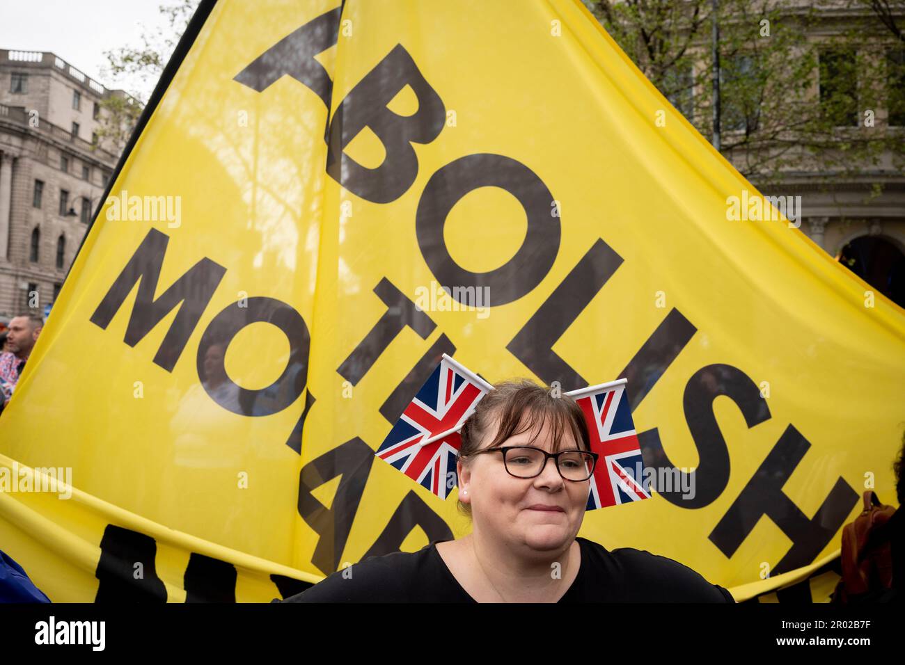 Un realista si trova di fronte a uno striscione tenuto da membri del gruppo anti-monarchico 'Repubblica' protesta a Trafalgar Square il giorno dell'incoronazione di re Carlo III, il 6th maggio 2023, a Londra, Inghilterra. Secondo la polizia incontrata, sono stati detenuti sul sospetto di violazione della pace, cospirazione per causare fastidio pubblico, e in possesso di articoli per causare danni criminali. Foto Stock