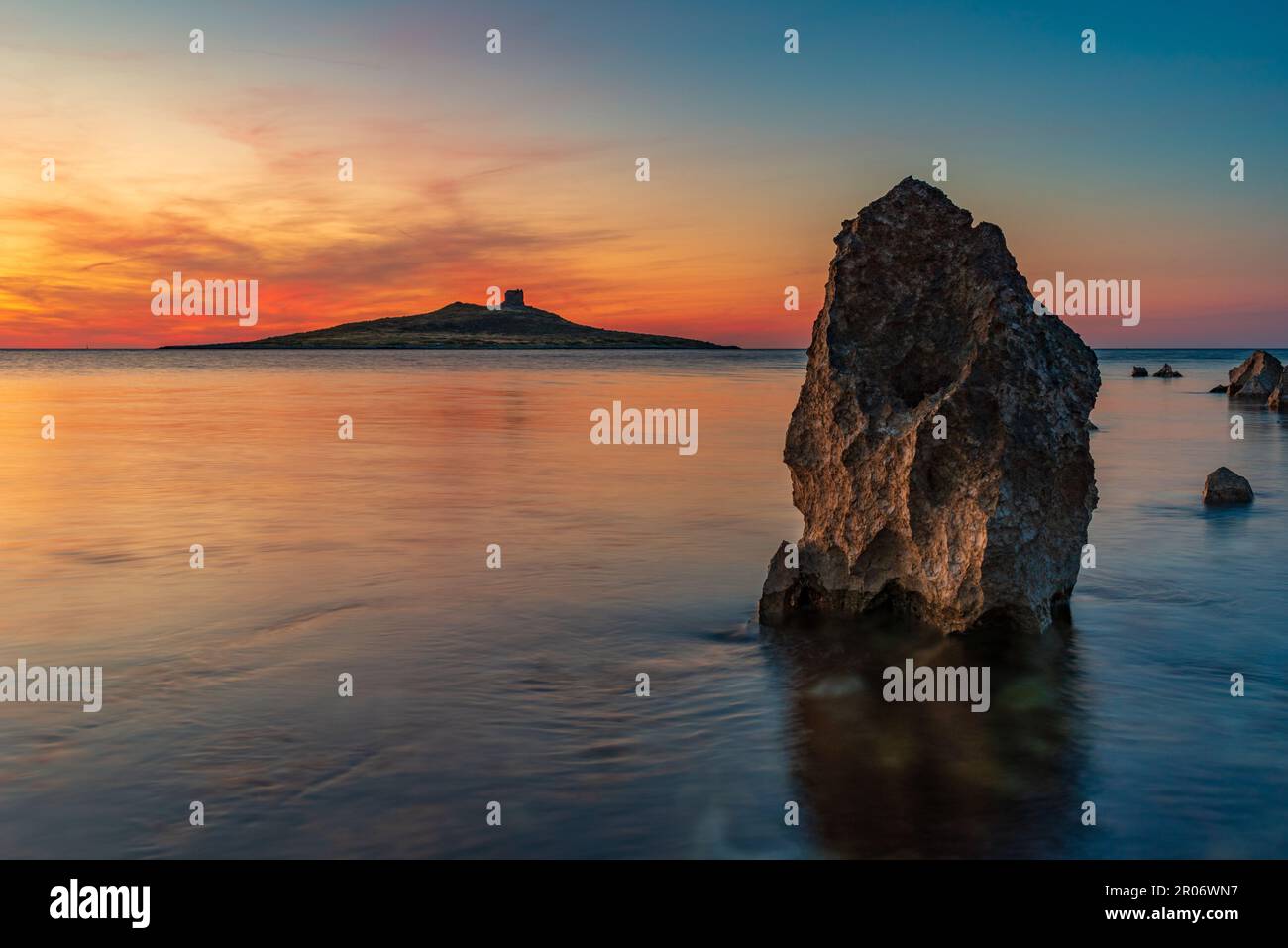 Il sole tramonta dietro l'isolotto di Isola delle femmine, in Sicilia Foto Stock