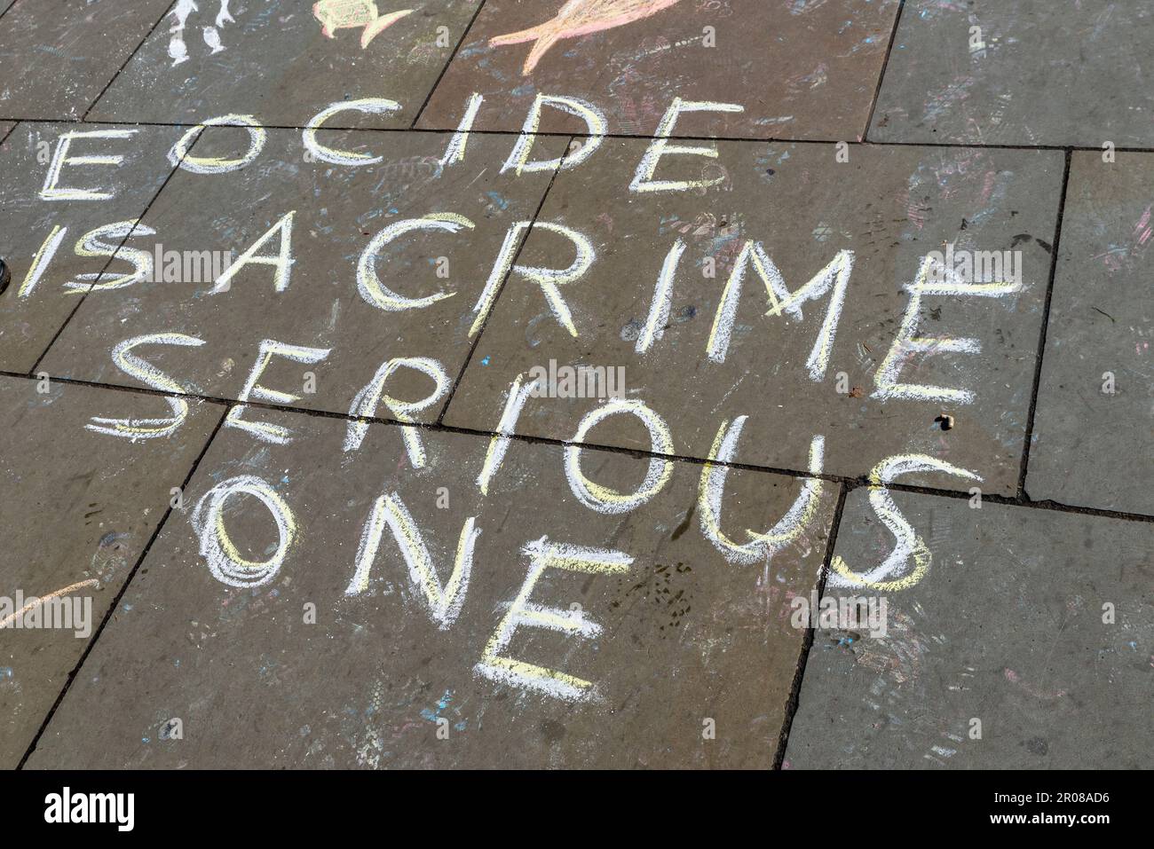 Graffiti con gesso dalla rivolta dell'estinzione all'accampamento intorno a Piazza del Parlamento di fronte alle Houses of Parliament, Londra, Regno Unito. Ortografia di Eocida Foto Stock