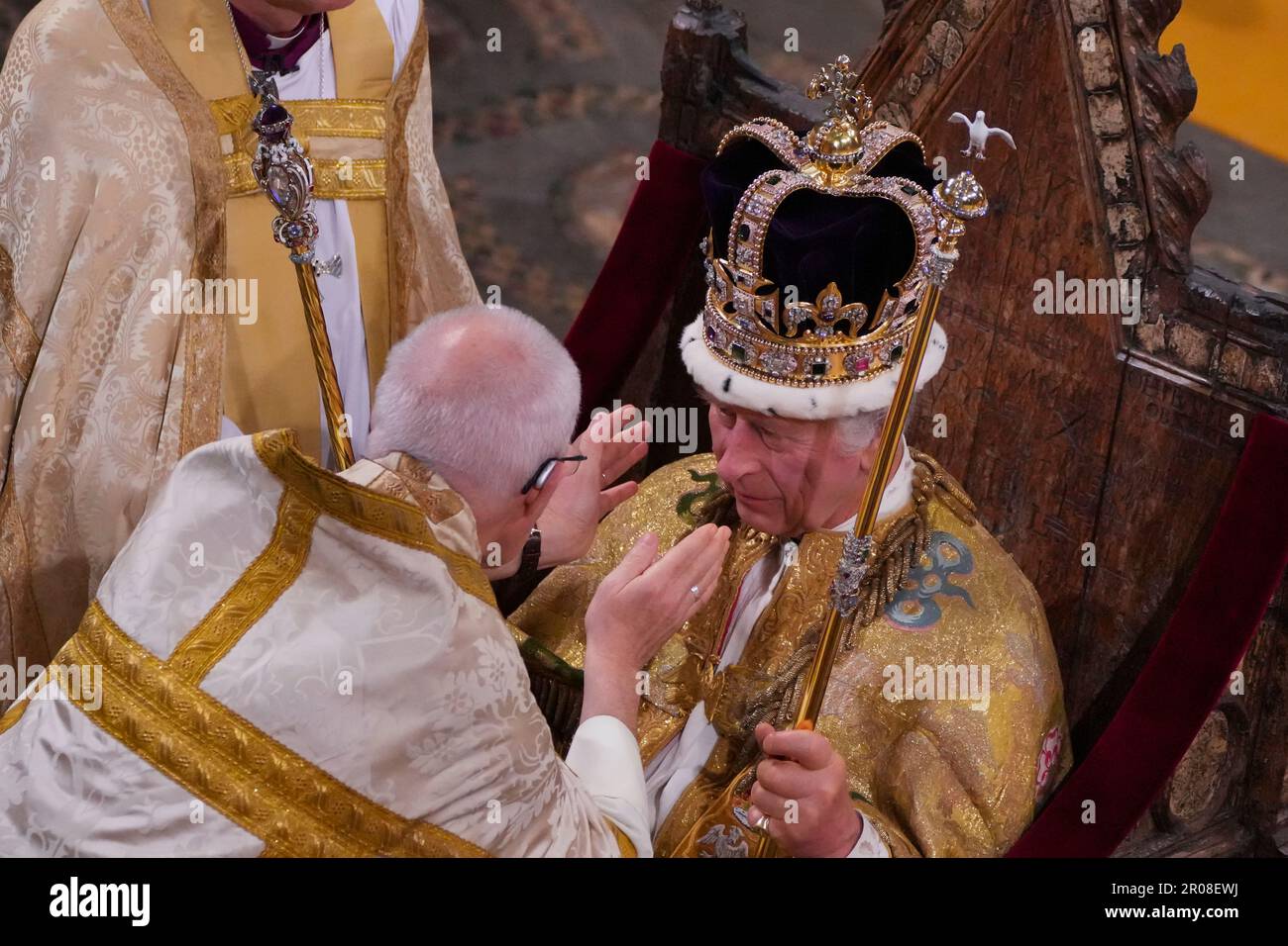 Re Carlo III, seduto nella Cattedra di Sant'Edoardo, nota anche come sedia di incoronazione, è incoronato con la Corona di Sant'Edoardo dall'Arcivescovo di Canterbury, il Reverendissimo Justin Welby, durante la sua cerimonia di incoronazione nell'Abbazia di Westminster, Londra. Il Re tiene lo sceptre del Sovrano con la colomba, nella sua mano sinistra, e lo sceptre del Sovrano con la Croce, nella sua mano destra, durante la cerimonia di incoronazione nell'Abbazia di Westminster, Londra. Data immagine: Sabato 6 maggio 2023. Foto Stock