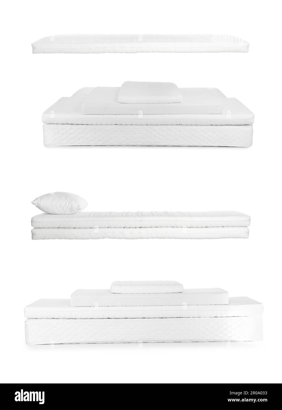 Set con nuovi e comodi materassi su sfondo bianco Foto Stock