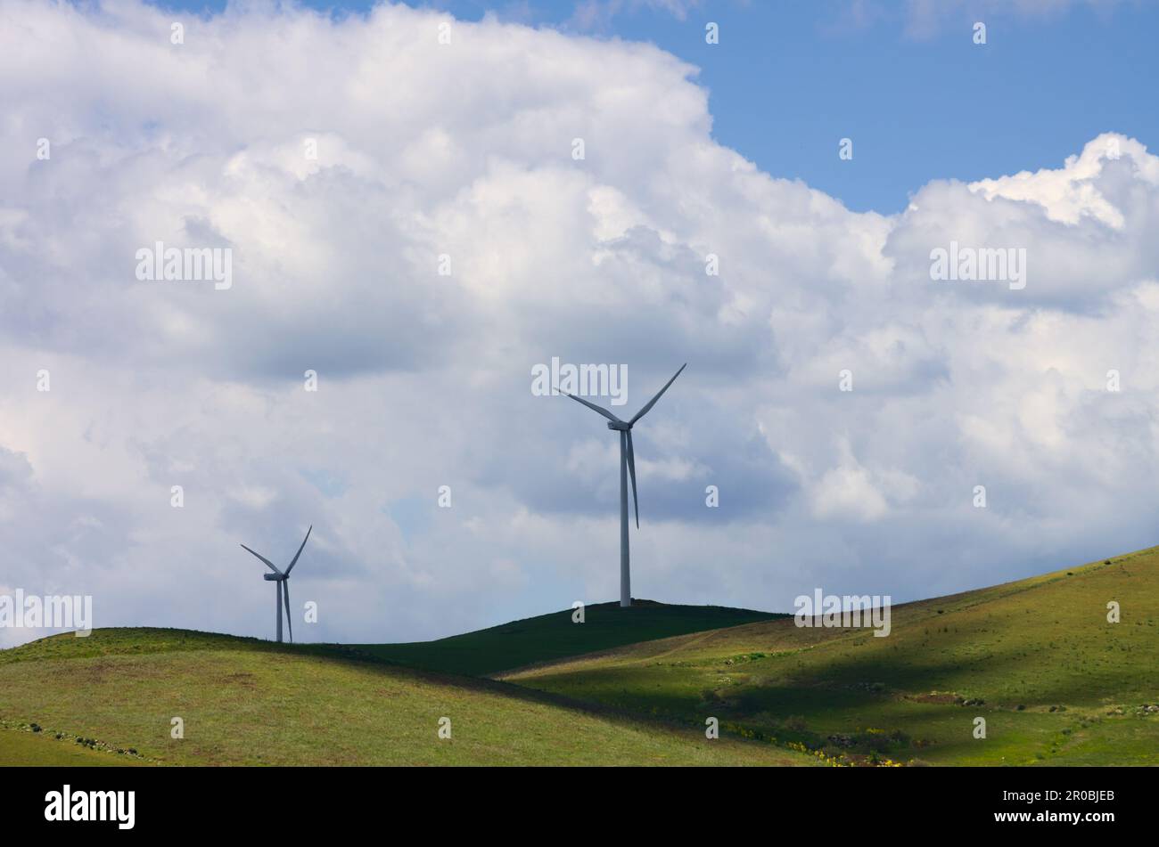 Turbine eoliche silhouette contro il cielo nuvoloso della Sicilia, Italia Foto Stock