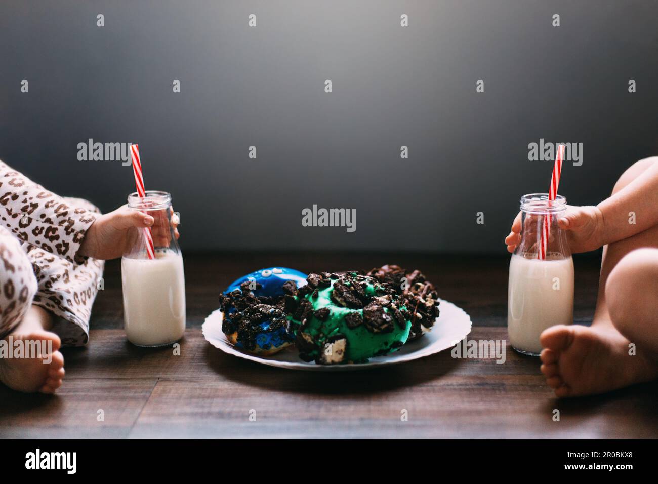 I bambini si divertano con le ciambelle con il latte Foto Stock