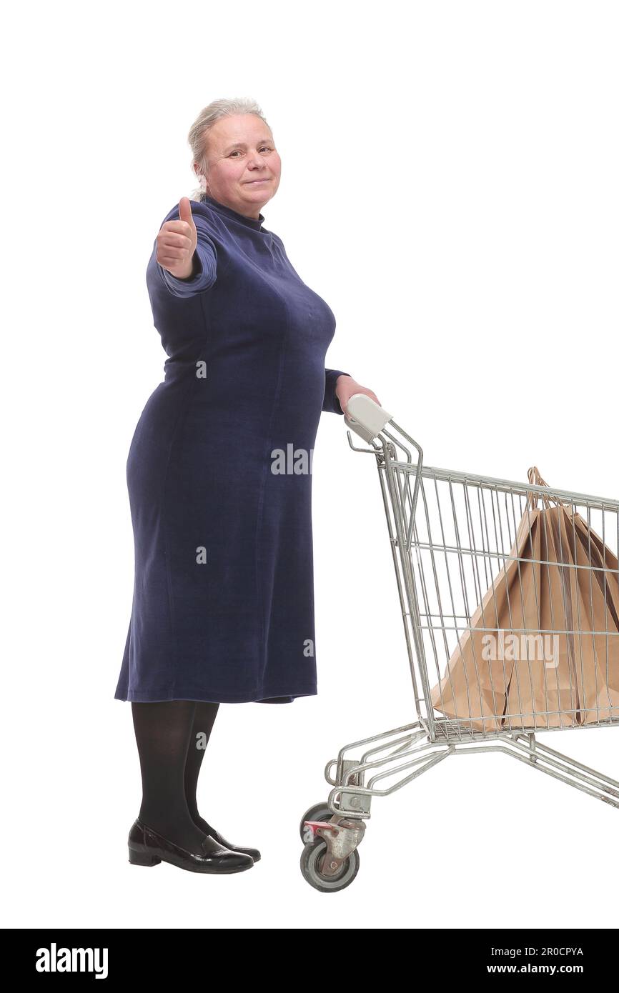 Signora matura allegra con un carrello che dà un pollice in su Foto Stock