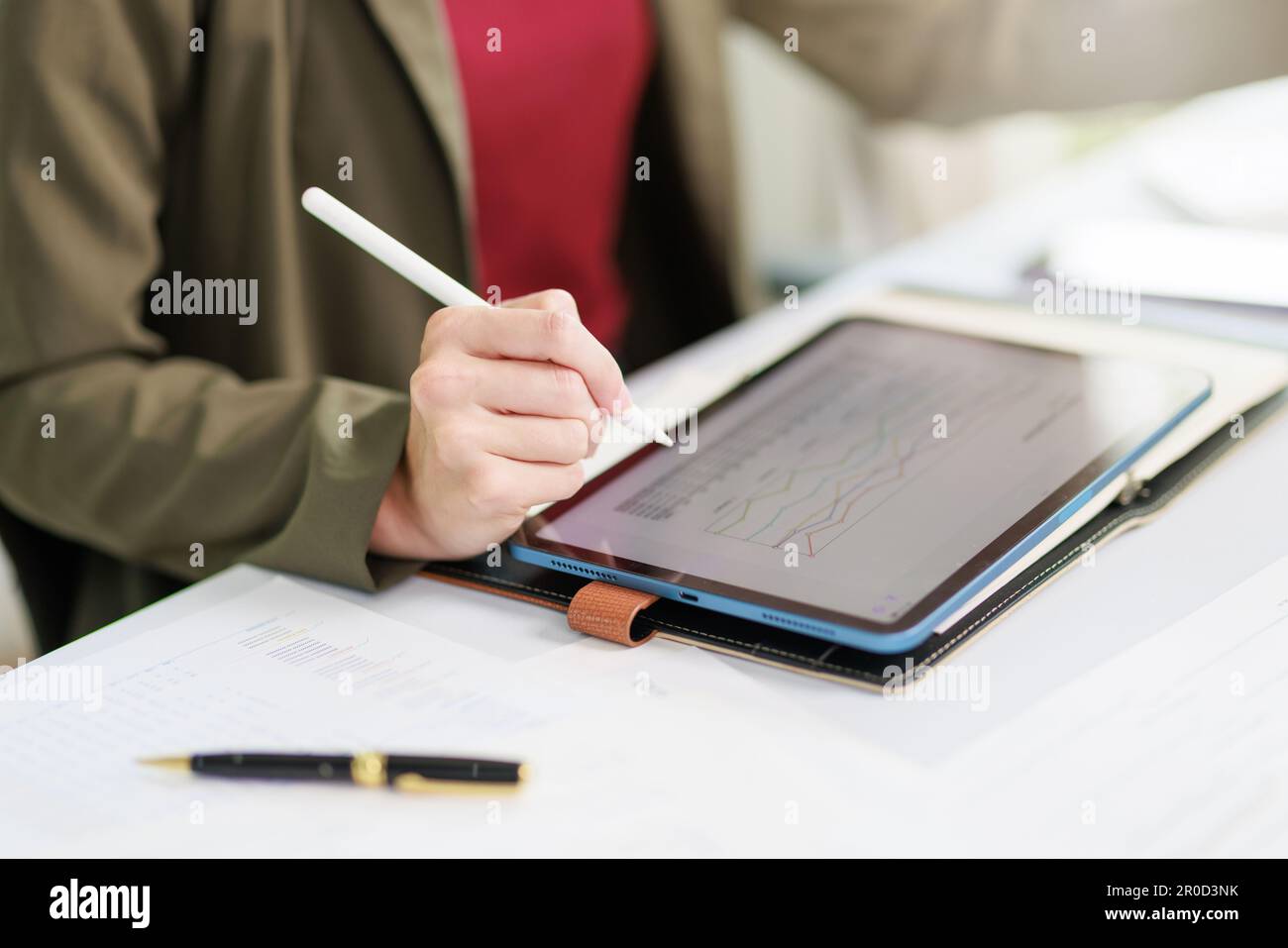 Concetto di business ufficio donna che lavora, Closeup businesswoman che controlla il suo piano di investimento con l'analisi di documenti e dati grafici di investimento aziendale Foto Stock