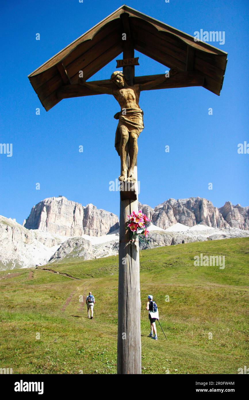 Croce di legno, due escursionisti in background, Alpi dolomitiche, Alto Adige, Italia Foto Stock