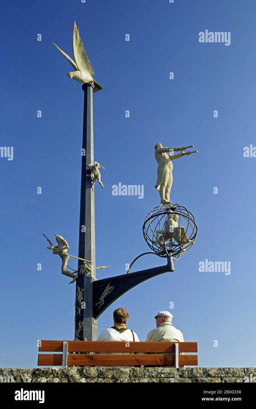 Persone e sculture sul lungomare sotto il cielo blu, Meersburg, Lago di Costanza, Baden Wurttemberg, Germania Foto Stock