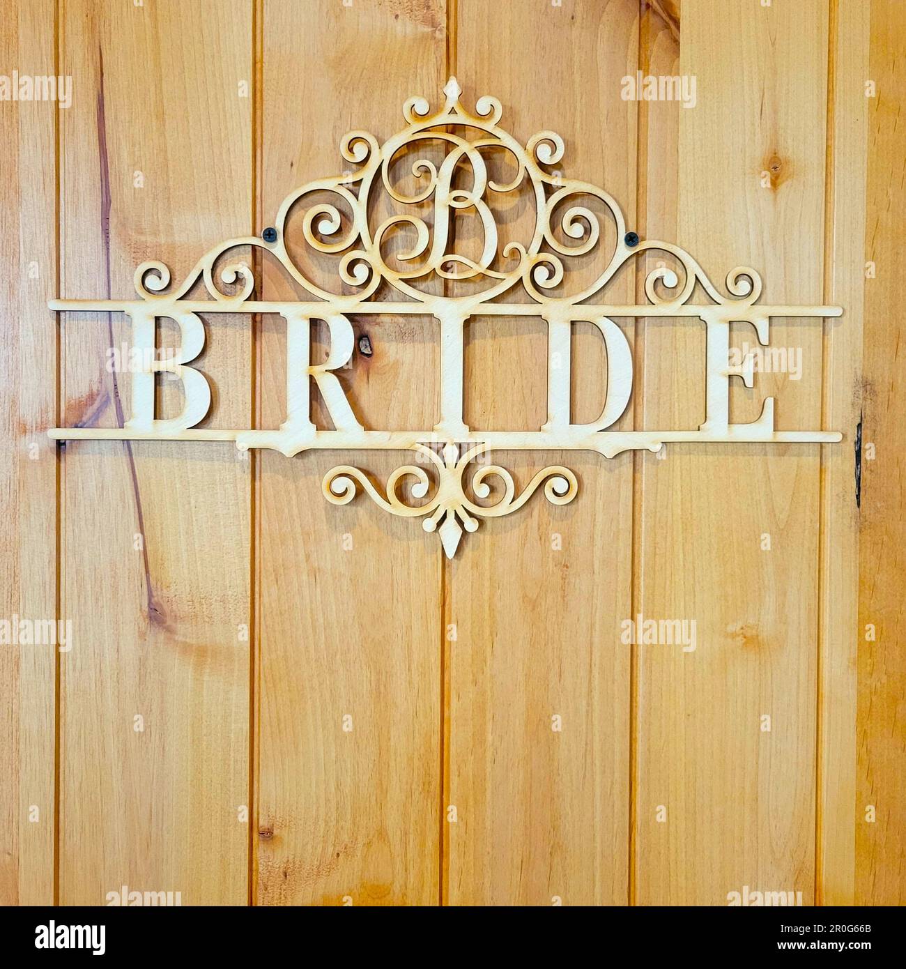 Un cartello di legno con la parola 'sposa' è appeso alla porta della stanza della sposa in un luogo di nozze. Foto Stock