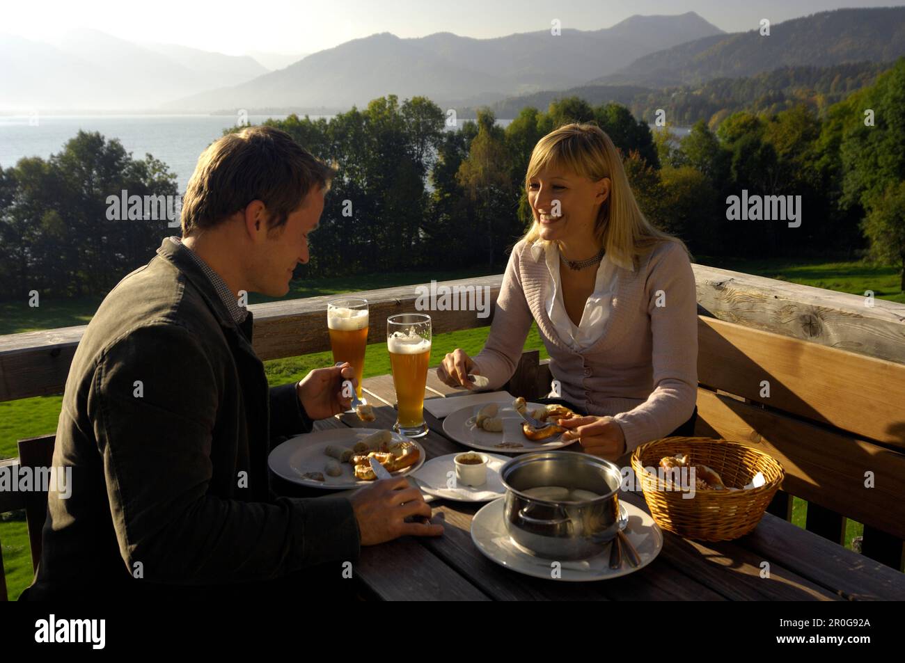 Coppia giovane in un giardino della birra sotto la luce diretta del sole, il lago Tegernsee, Baviera, Germania, Europa Foto Stock