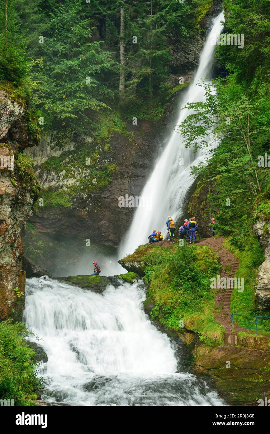 Canyoning serverale di fronte ad una cascata, Cavalese, Val di Fiemme, Lagorai, Dolomiti, Patrimonio dell'Umanità dell'UNESCO Foto Stock